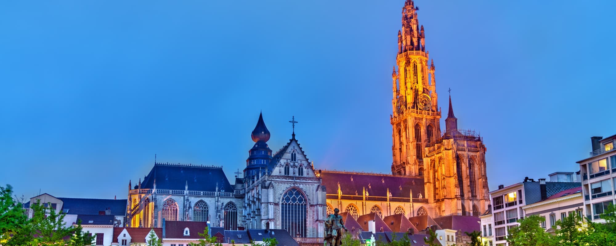 The Cathedral of Our Lady with illuminated tower against a twilight sky.