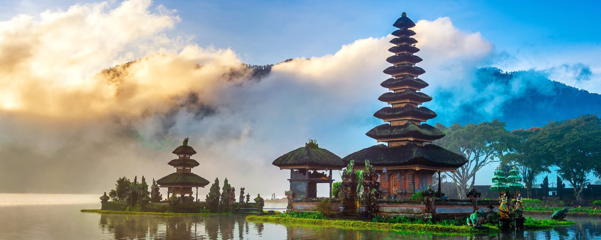 Ulun Danu Beratan Temple on a lake with a pagoda and vibrant sky in Bali.